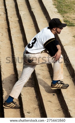 ZAGREB, CROATIA - MAY 03, 2015: Baseball match Baseball Club Zagreb in blue jersey and Baseball Club Pirates in white jersey. Baseball player standing on the stairs, waiting for his turn to play