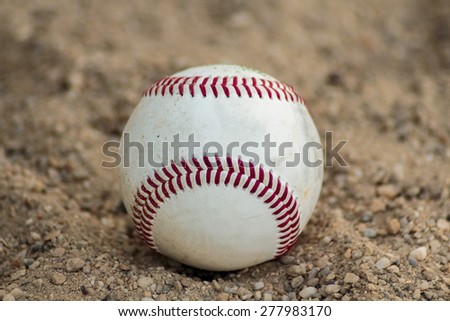 Baseball ball on gravel