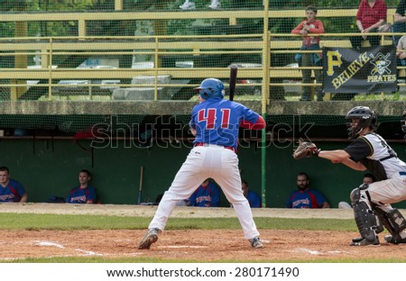 ZAGREB, CROATIA - MAY 03, 2015: Baseball match Baseball Club Zagreb in blue jersey and Baseball Club Pirates in white jersey. Baseball batter and catcher prepared for incoming ball