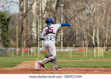 ZAGREB, CROATIA - MARCH 28, 2015: Baseball match Baseball Club Zagreb and Baseball Club Nada.  Baseball catcher on playing ground, ball is flying throw the air
