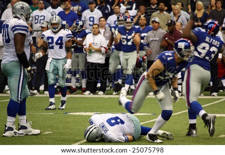 DALLAS, TEXAS - DEC 14: Dallas Cowboys Quarterback Tony Romo is sacked by the NY Giants defense during a game at Texas Stadium  in Dallas, Texas, on Sunday, December 14, 2008.
