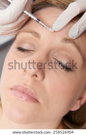 Woman Having Botox Injection In Forehead