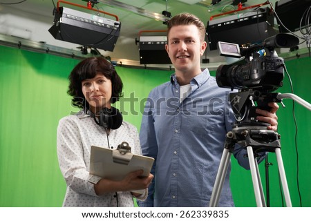 Portrait Of Cameraman And Floor Manager In Television Studio