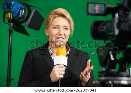 Female Journalist Presenting Report In Television Studio