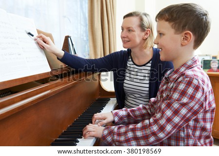 Similar – Image, Stock Photo Smiling child playing piano in cozy room in daylight