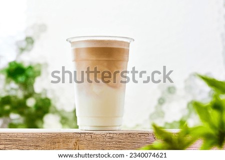 Caffe latte, coffee poured into milk in a plastic cup Foto d'archivio © 