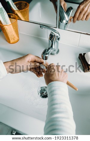 Similar – Foto Bild Alte Frau wäscht Bambus-Zahnbürste mit Wasser und wäscht ihre Zähne