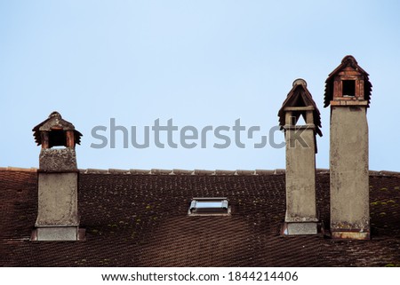 Three chimneys on a rooftop of a historic building in the old town of Le Landeron, CH Photo stock © 