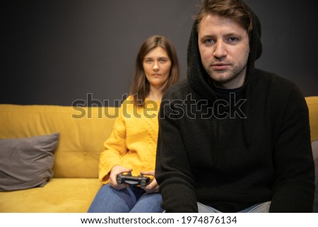 Similar – Image, Stock Photo Unemotional couple sitting on asphalt road in city