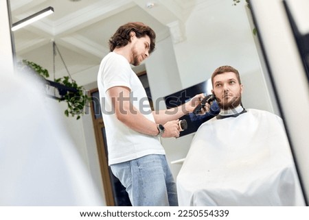 Similar – Image, Stock Photo Ethnic barber trimming mustache of client in hairdressing salon