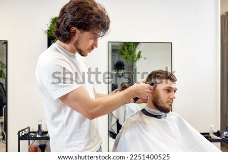 Similar – Image, Stock Photo Ethnic barber trimming mustache of client in hairdressing salon