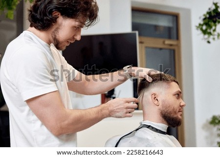 Similar – Image, Stock Photo Ethnic barber trimming mustache of client in hairdressing salon