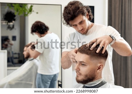 Similar – Image, Stock Photo Ethnic barber trimming mustache of client in hairdressing salon