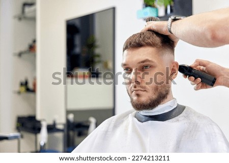 Similar – Image, Stock Photo Ethnic barber trimming mustache of client in hairdressing salon