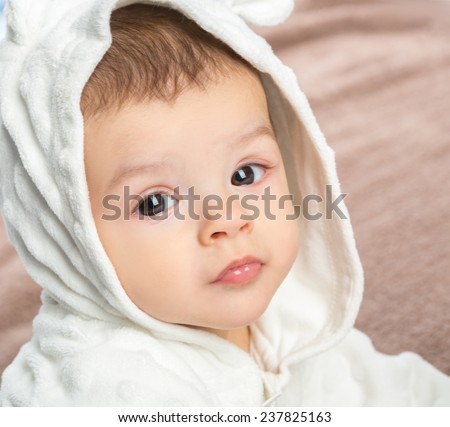 baby portrait with towel after bath. Charming baby. Beautiful baby under  blanket