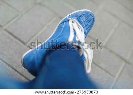 blue shoes standing by street,from above