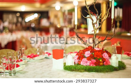 the table with flowers is served a holiday dinner in restaurant