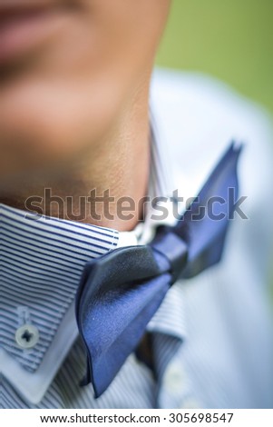 the blue bow tie on the groom