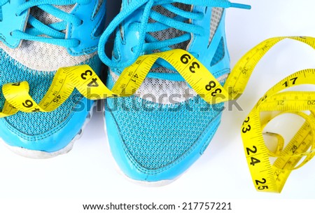 Sport shoes and measuring tape. Fitness concept