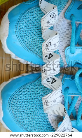 Sport shoes and measuring tape. Fitness concept.sneakers, centimeter.weight loss, running, healthy eating, healthy lifestyle concept