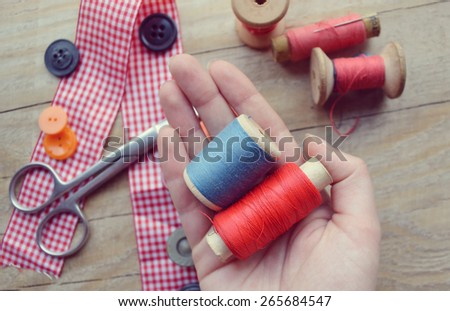 thread for sewing, supplies and accessories for sewing on a light wooden table