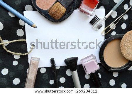 set of cosmetics, contraceptives, blank sheet of paper