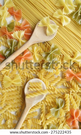 Different types of pasta, macro view on a wooden table