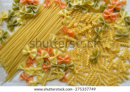 Metal pasta maker machine and ingredients for pasta,Raw homemade pasta ,Still life of preparing pasta on rustic wooden background