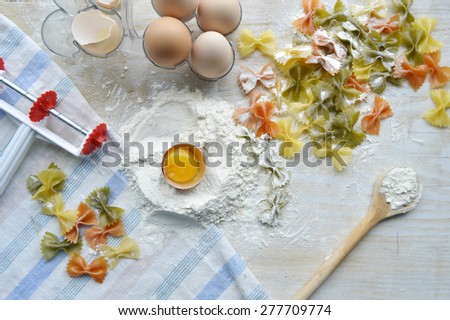 still life with raw homemade pasta and ingredients for pasta.process of cooking pasta