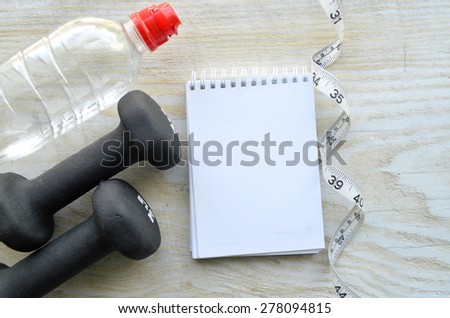 a bottle of water .running, healthy eating, healthy lifestyle concep.dumbbells, exercise