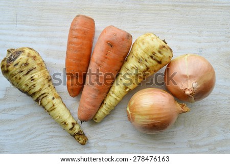 natural, organic vegetables, parsnips, potatoes,carrot, beet, onion, celery knife for cutting vegetables on a wooden table