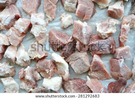 cut pieces of frozen meat