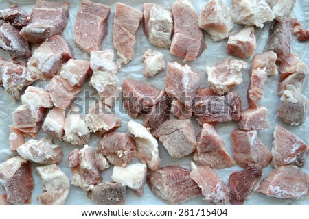 cut pieces of frozen meat