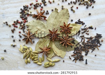 bay leaf, cardamom, star anise, cloves on a wooden table