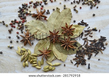 bay leaf, cardamom, star anise, cloves on a wooden table