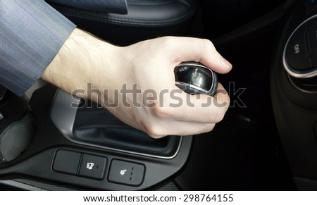 transportation and vehicle concept - man shifting the gear on car manual gearbox.Parking gear..Hand of the driver of the car , toned.
