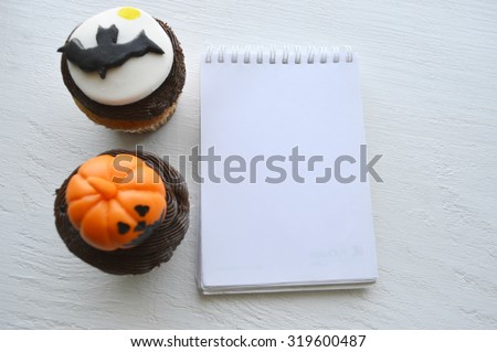 Happy Halloween Cupcakes.Halloween cookies.recipe book.Preparation for sweet cupcakes with sweet cream