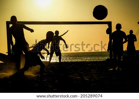 FORTALEZA, BRAZIL - June 18, 2014: Local Brazilians playing football on Mucuripe beach in Fortaleza, one of the host cities of the 2014 FIFA World Cup.