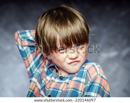 Emotional portrait of red-haired boy, attractive for advertising