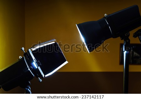 Duel of two professional photo flash lamps in studio