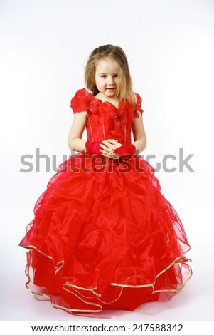 Cute little princess dressed in red dancing. Isolated on white background. Children fashion.
