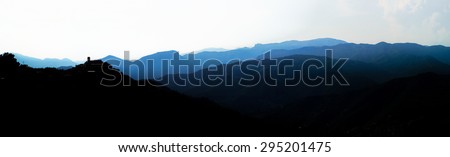Beautiful panoramic bird-fly view to silhouettes of mountains, travel concept. Italy.