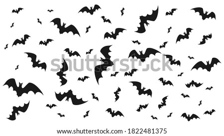 Vector illustration of flying bats on a light background.  Symbol of Halloween and fear.