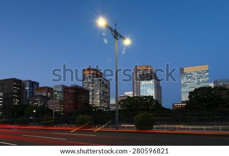 Tokyo, Japan - May 25, 2015: A Street at Dusk Near Imperial Palace, Tokyo, Japan. Photo Shows the Tail Red Lights and Tall Modern Buildings.