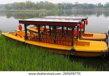Beijing, China - April 27, 2015: Traditional Chinese Boat Parked at a Lake at the Old Summer Palace, also Known as Yuanmingyuan, was a complex of palaces and gardens in Beijing.