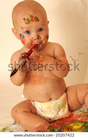 6-months Baby-girl with dirty face and hands because she painting