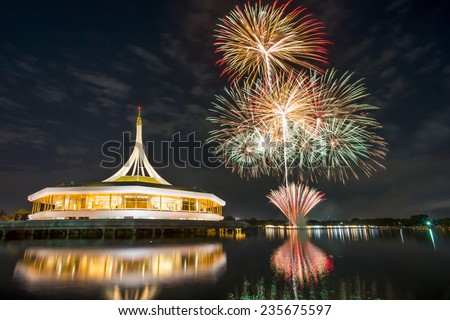 The happy family looks beautiful colorful holiday fireworks in the evening sky with majestic clouds, long exposure