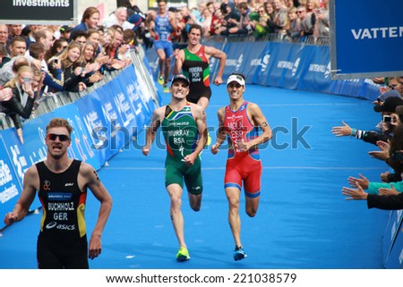 STOCKHOLM - AUG 23: Richard Murray and Mario Mola fights to reach the 4th place after bronze medalist Gregor Buchholz in the ITU World Triathlon series event August 23, 2014 in Stockholm, Sweden
