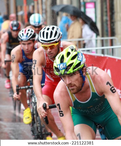 STOCKHOLM - AUG 23: Dan Wilson (AUS) and a lot of competitors chasing him in the rain during the Men\'s ITU World Triathlon series event Aug 23, 2014 in Stockholm, Sweden