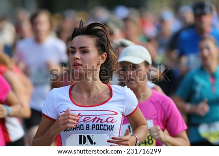 STOCKHOLM - SEPTEMBER 13, 2014: Young beautiful woman running in the Halvmarathon running event (21 km), Sept 13, 2014 in Stockholm, Sweden